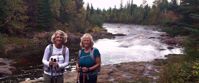 Women smiling by river on superior hiking trail
