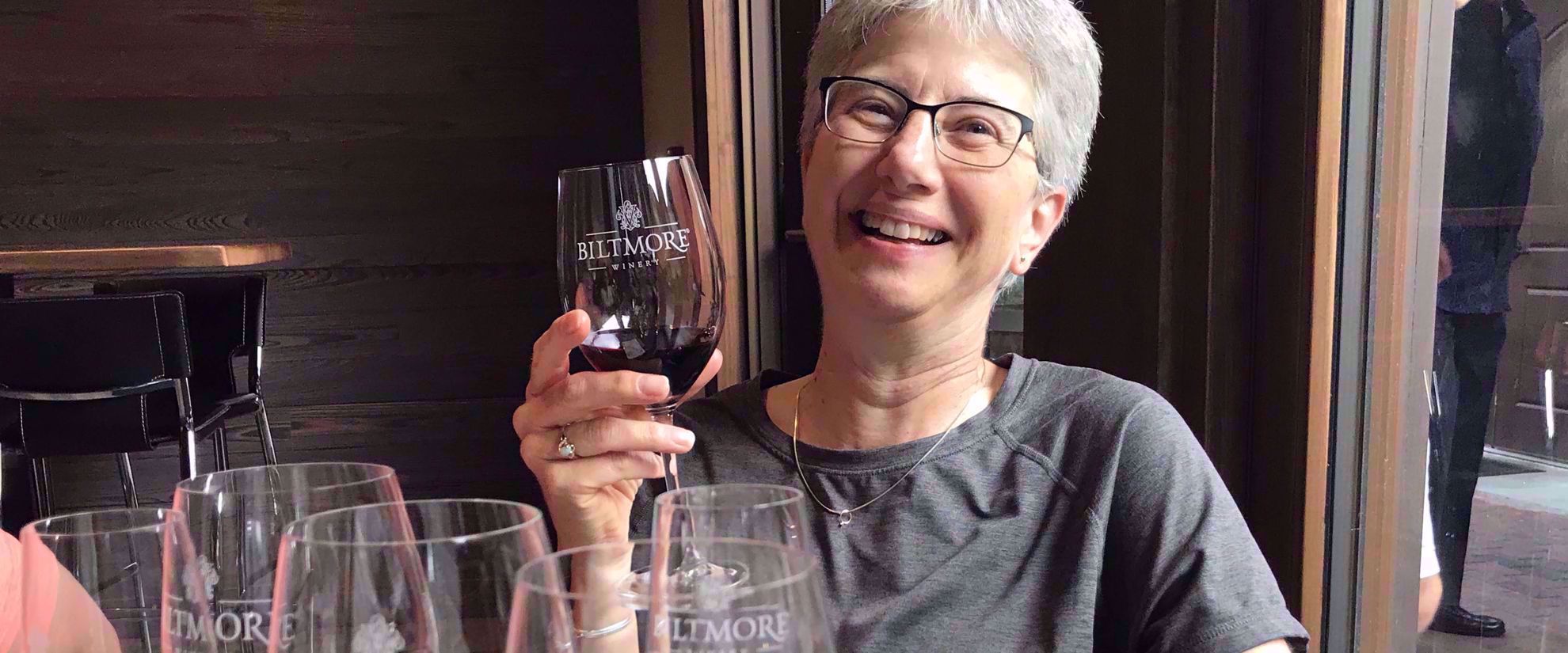 Woman enjoying wine on travel tour through blue ridge
