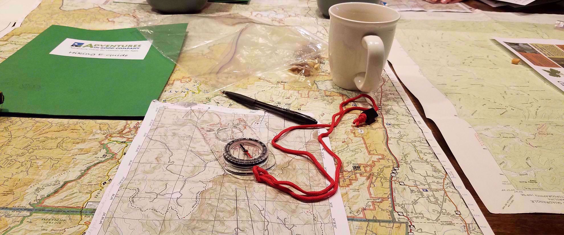 map compass coffee and pen