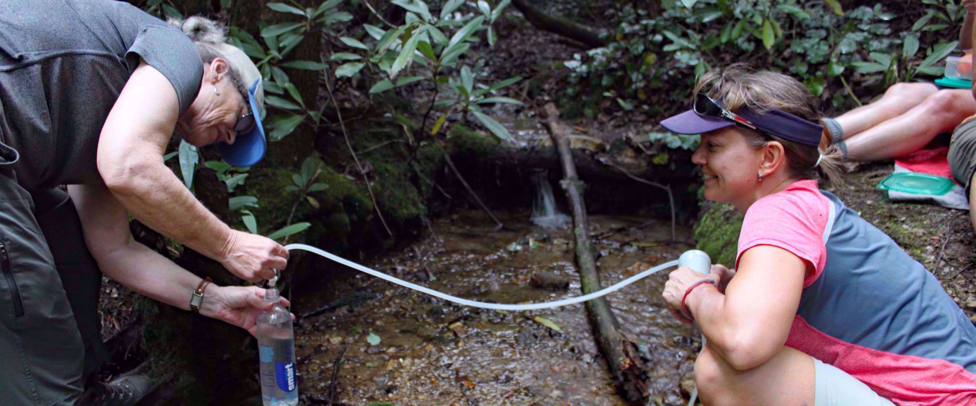 purifying water on group travel tour though appalachian mountains