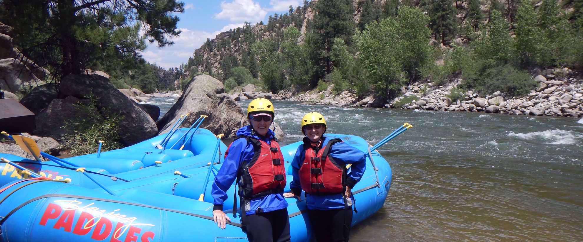 women preparing to raft on group trip to colorado rockies