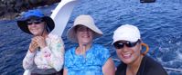 women smiling on boat tour through galapagos islands