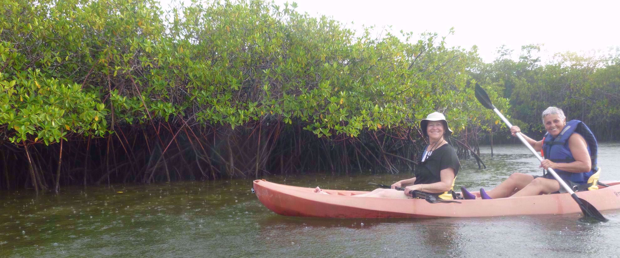 women kayaking on group travel tour through galapagos islands