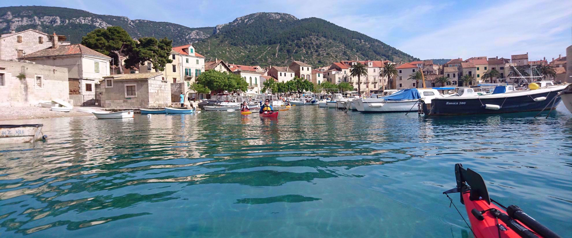 kayaking through canal with sailboats croatia
