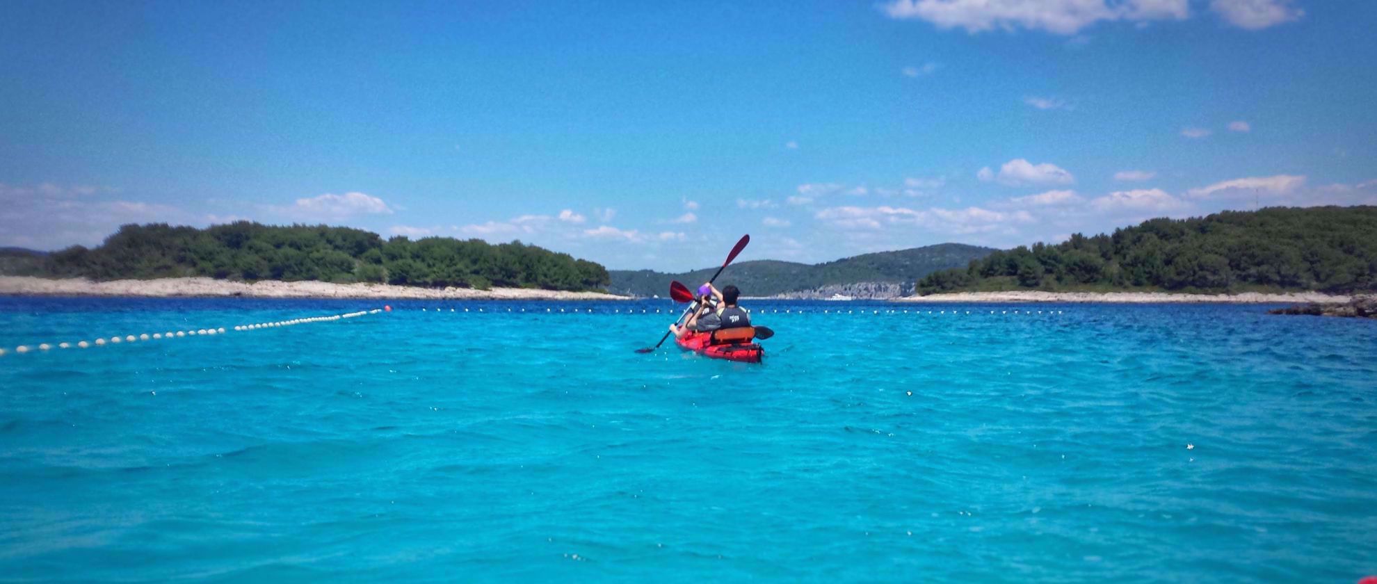 stunning blue water with orange kayak croatia