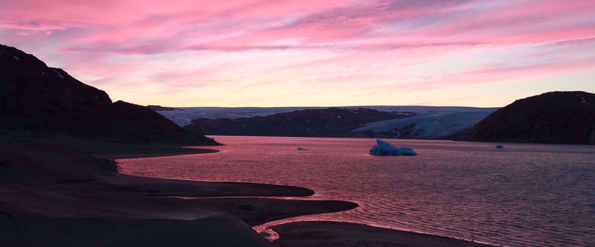 pastel pink sunset over lake in greenland