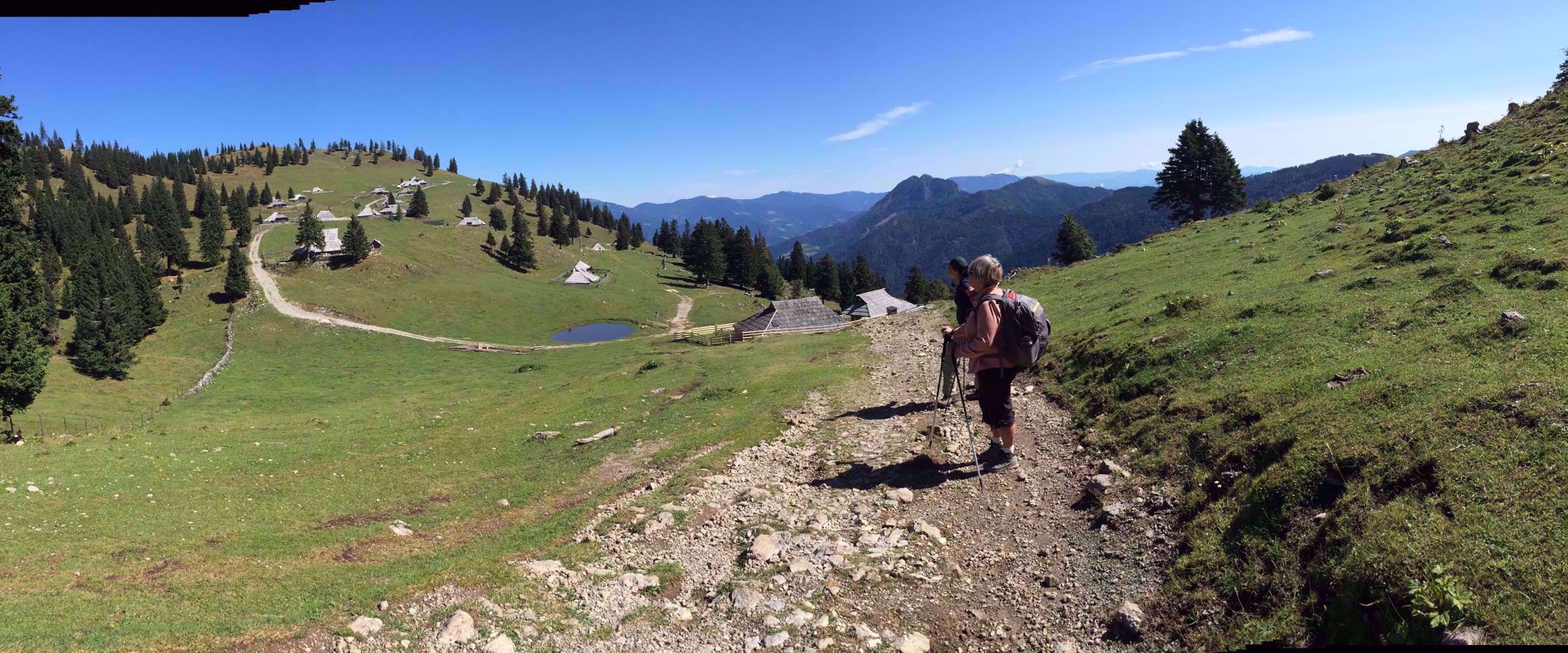 women hike gravel path through slovenia
