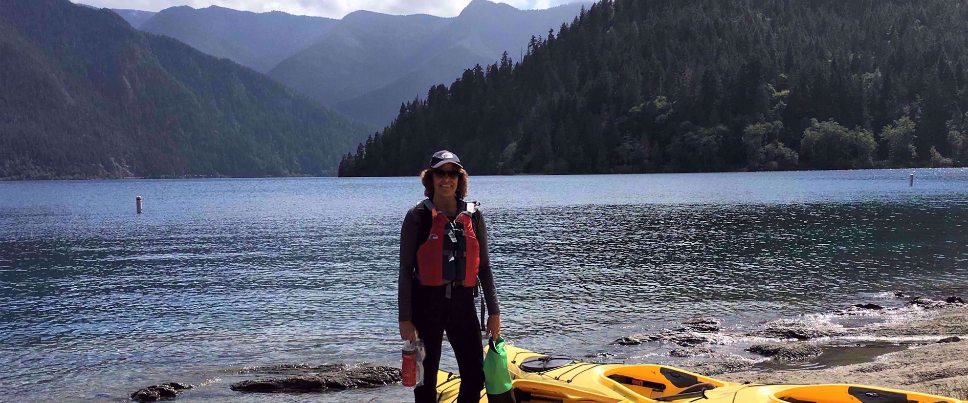 Picture of Pacific Northwest Escape: The San Juan Islands & Olympic National Park woman with yellow kayak prepares to kayak olympic national park