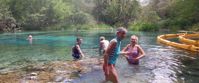 women swimming in blue suwannee river