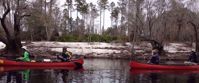women laughing and smiling in red kayaks on suwannee river