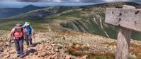 Picture of Slackpacking Maine women hiking to saddle trail sign