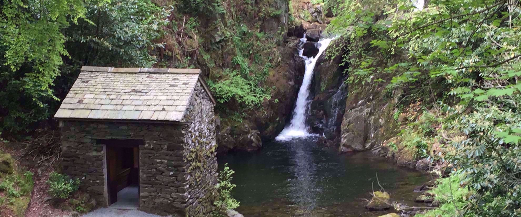 waterfall and abandoned rock building in forest Grasmere uk