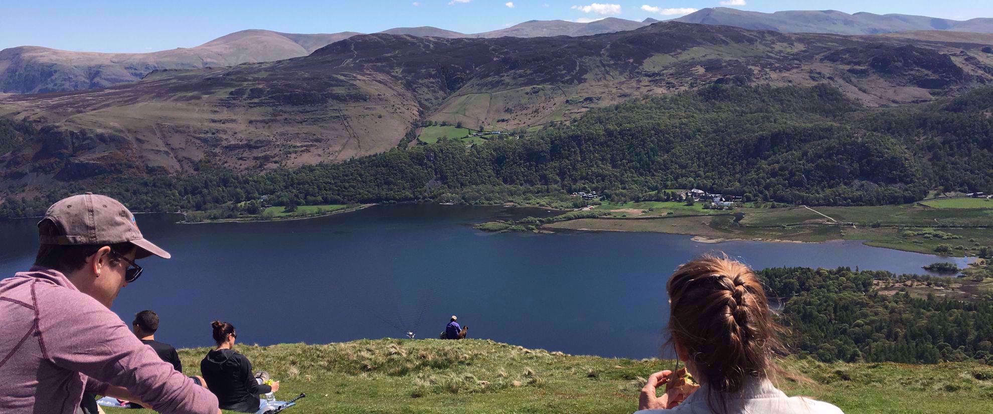 enjoying lunch with view of lake on hike in grasmere uk