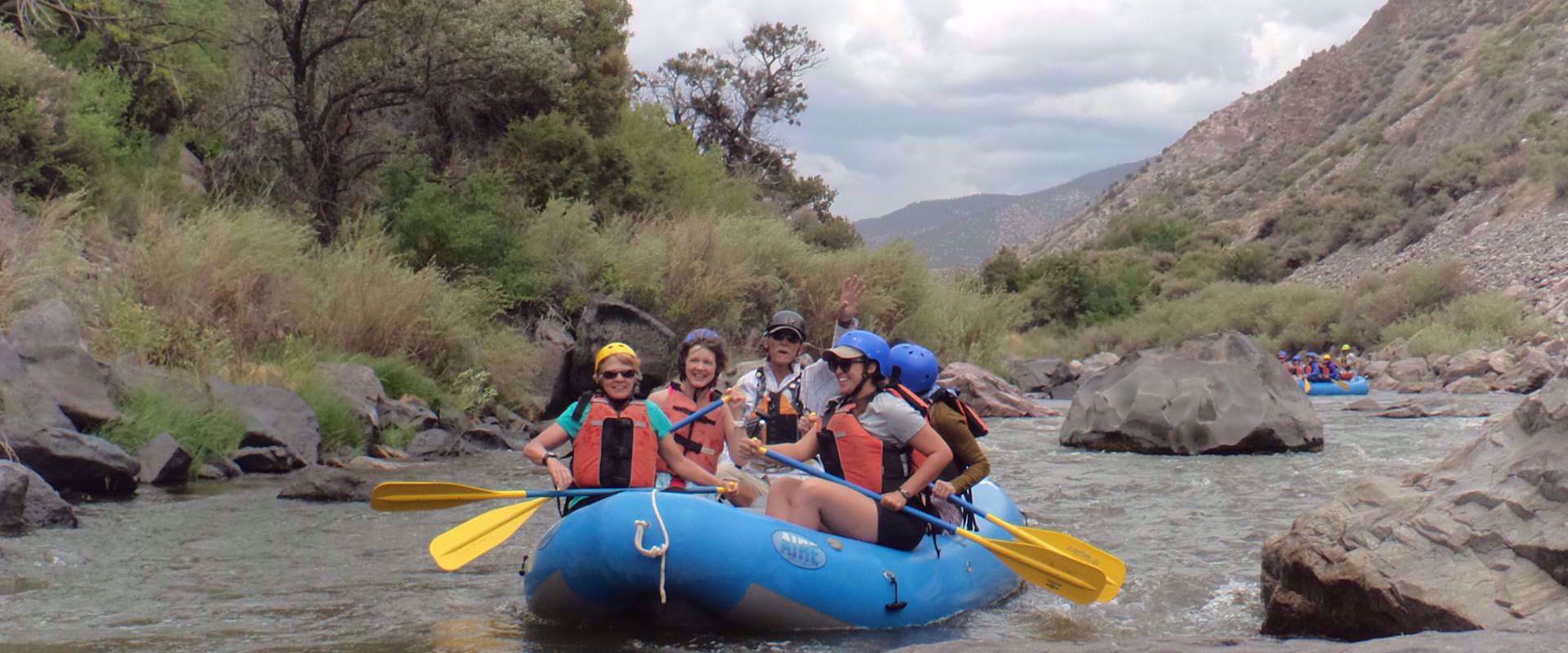 women's adventure travel rafting through river in santa fe