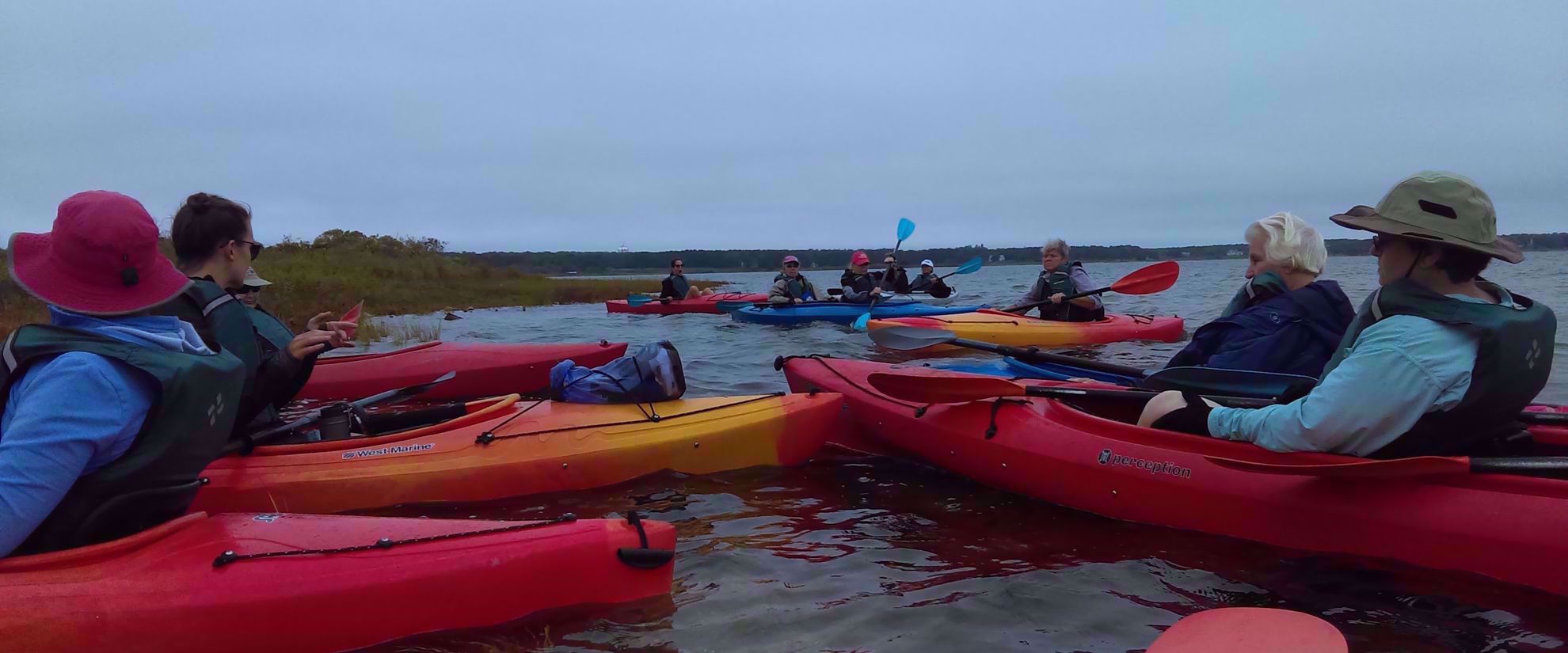 Women's travel group kayaking in Cape Cod