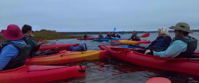 Women's travel group kayaking in Cape Cod