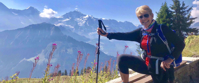 woman smiling hiking through swiss alps