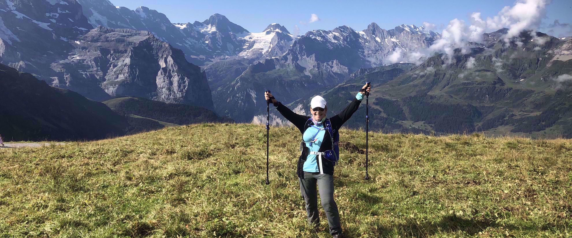 victorious woman hiking through swiss alps