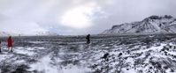 women hiking across ice field