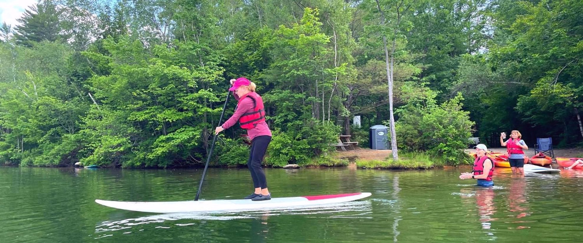 learn to stand up paddle board on a women's adventure tour